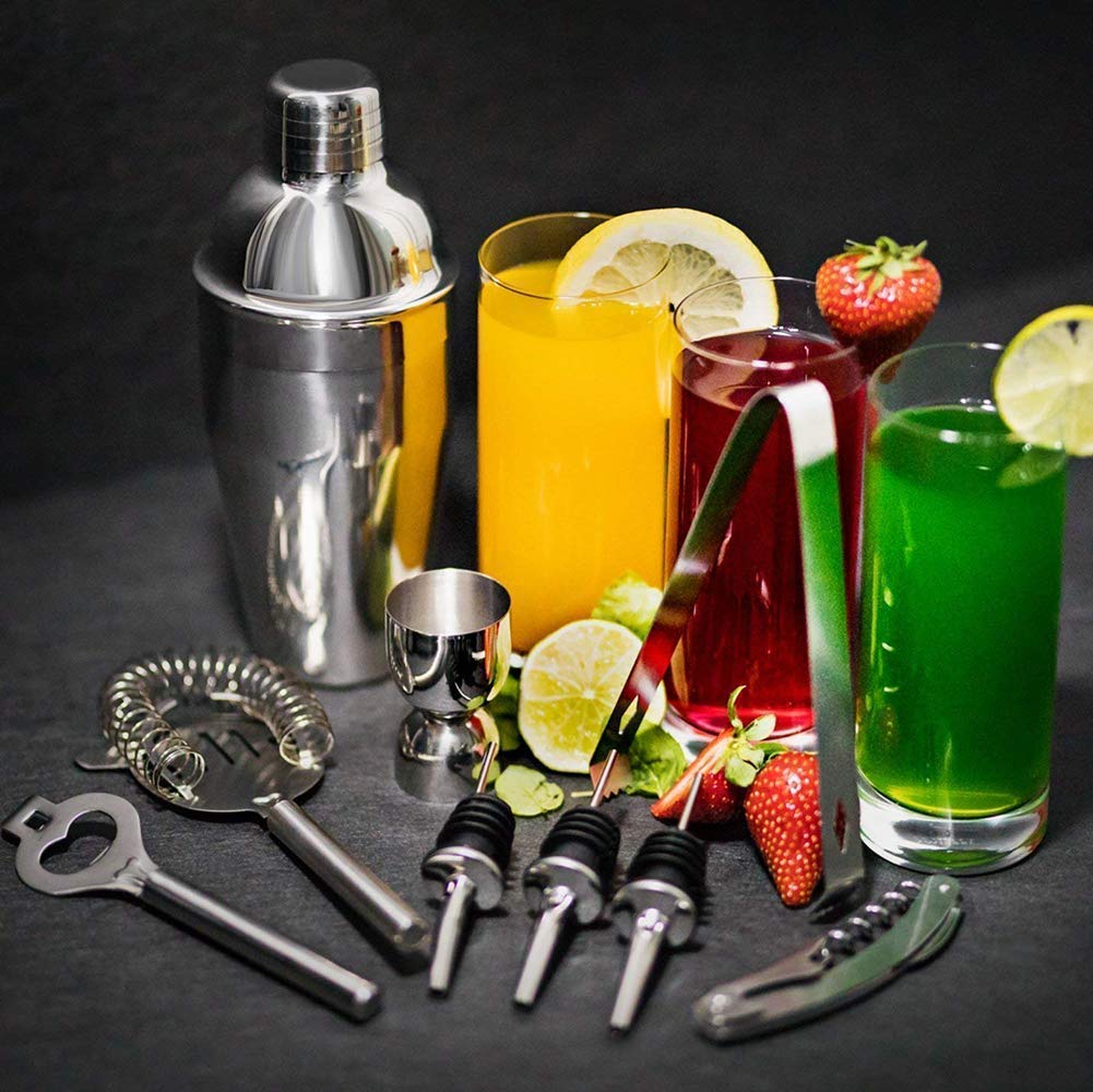 Neatly arranged home bar with cocktail tools, glassware and fresh citrus ready for game day