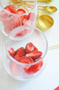 frozen strawberry slices in a cocktail glass
