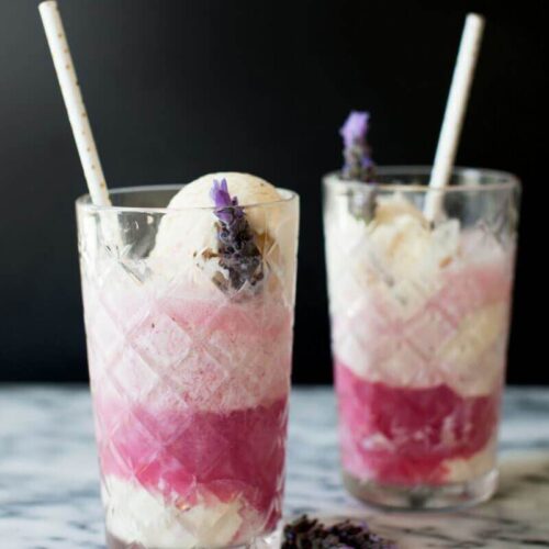 Boozy black cherry floats on a marble table.
