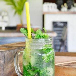 The perfect mojito served with lime and fresh mint in a mason jar.