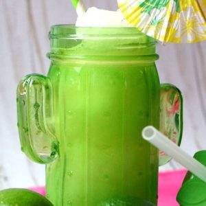 Yummy Frozen Agave Margarita drinks with limes in a cactus jar