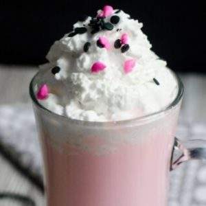 Recipe for Valentine Strawberry Hot Chocolate topped with sprinkles and whipped topping.