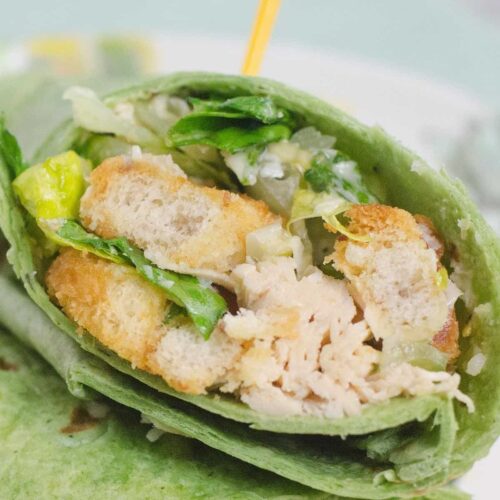 An herb and spinach wrapped filled with chicken caesar salad.
