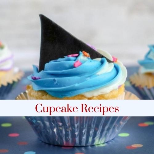 A cupcake decorated with a shark fin with text: cupcake recipes.